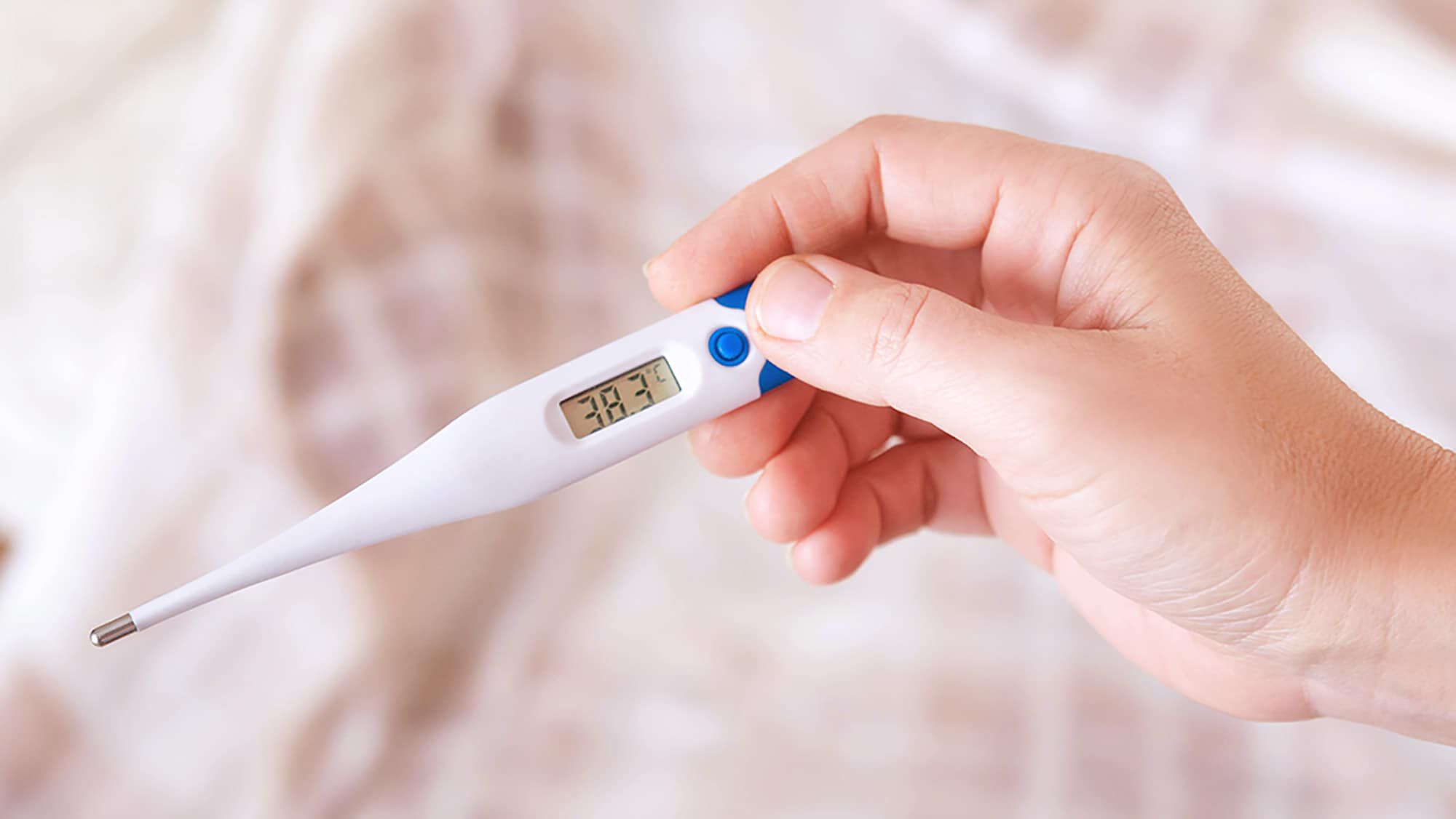 Free Photo  Medical thermometer indicating high temperature on the face  masks-coronavirus