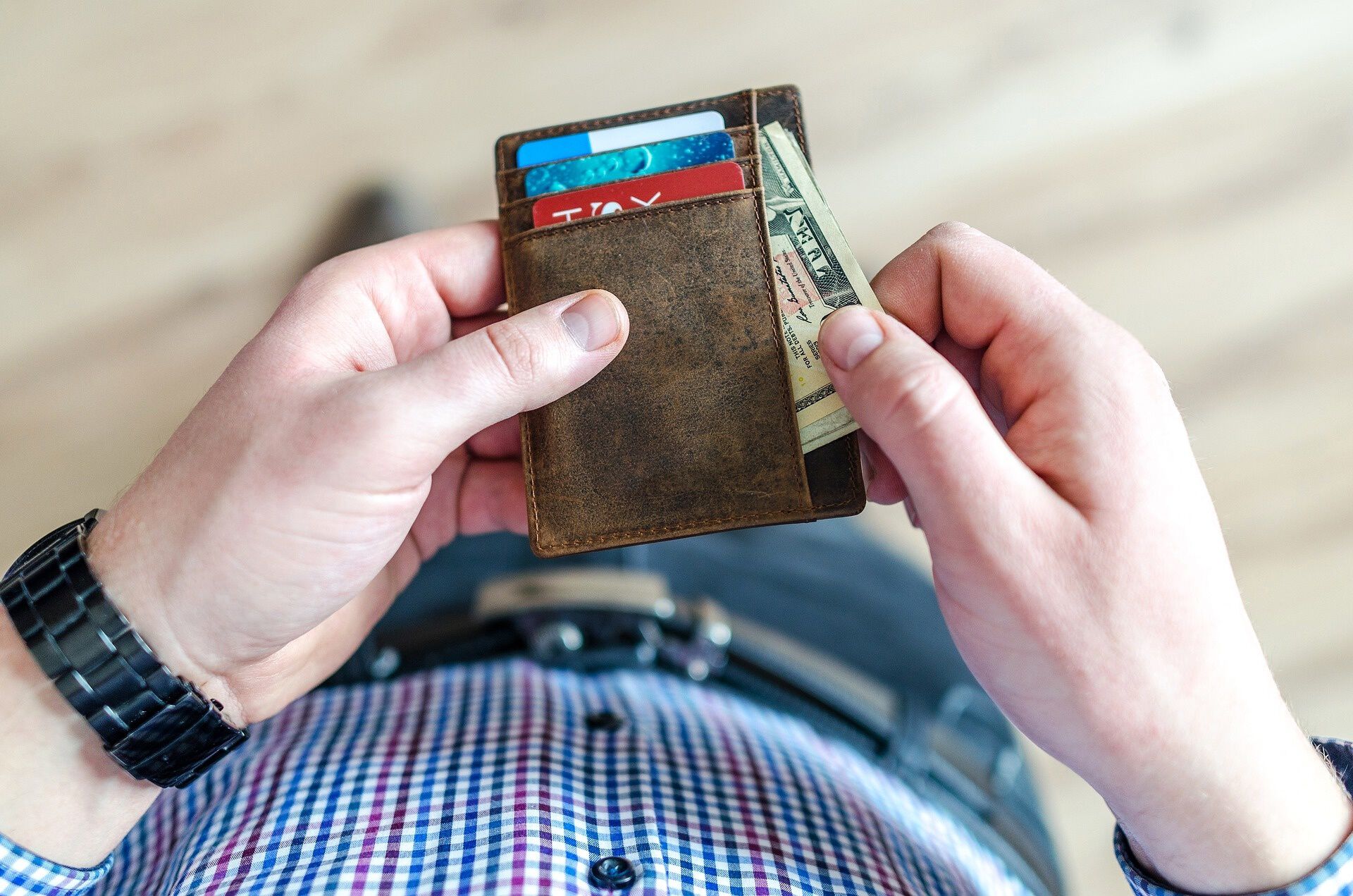 man pulling money from his wallet